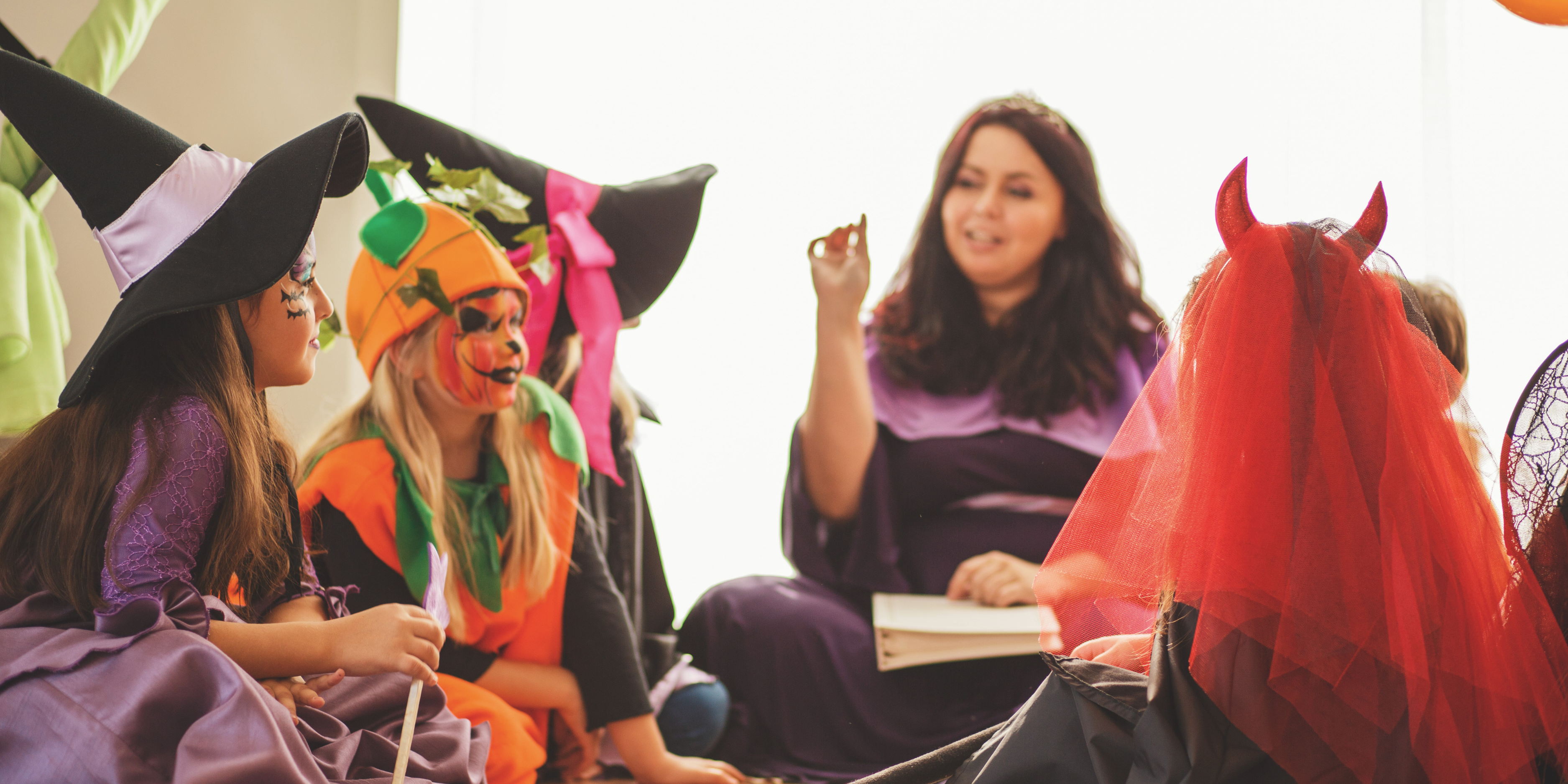 Parent telling children spooky stories for Halloween