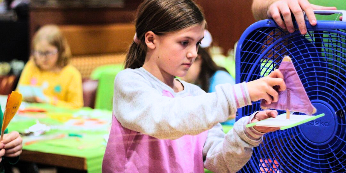 Young Girl Engaged in a STEM Science Experiment