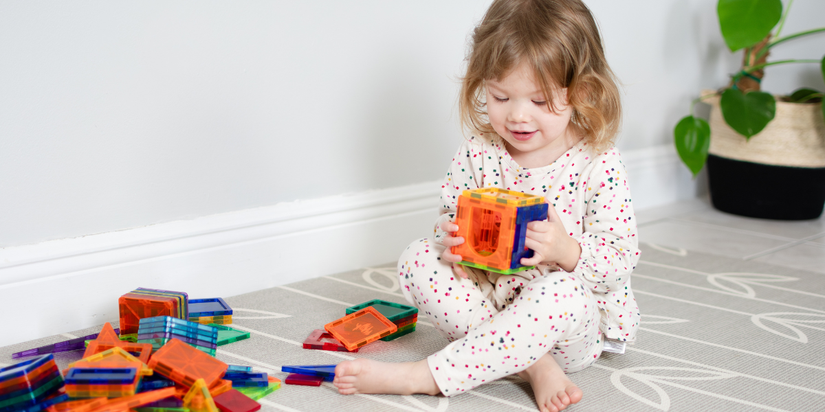 A small child engineering with their STEM toys.