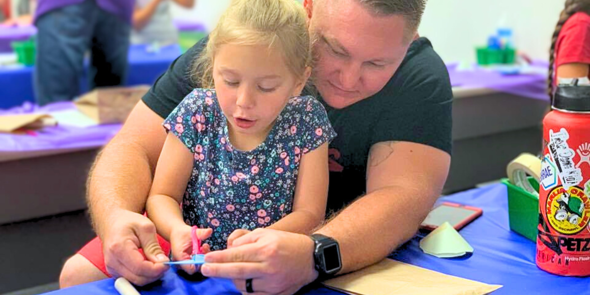 A parent and child work together on a hands-on project, fostering creativity, problem-solving, and teamwork.