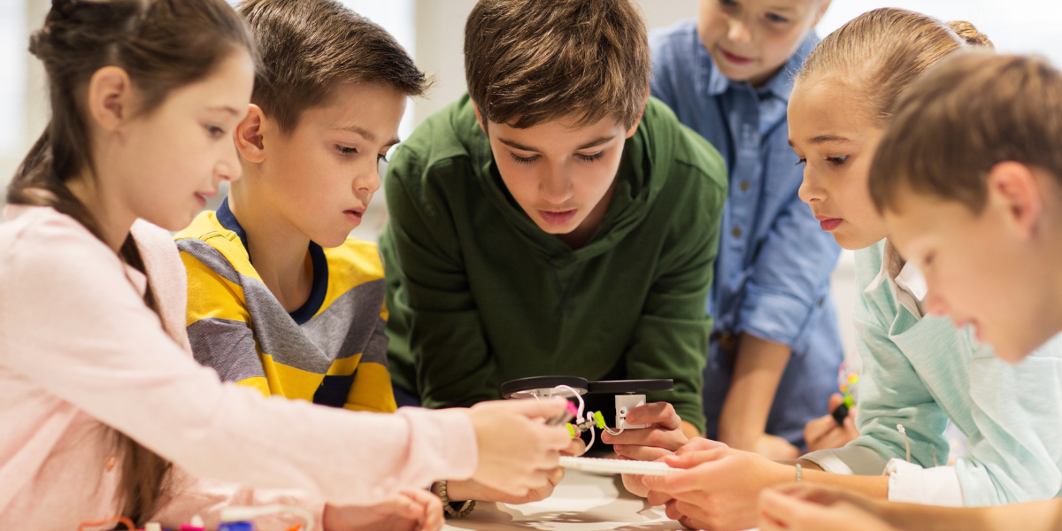 A group of children gathered around their new invention.