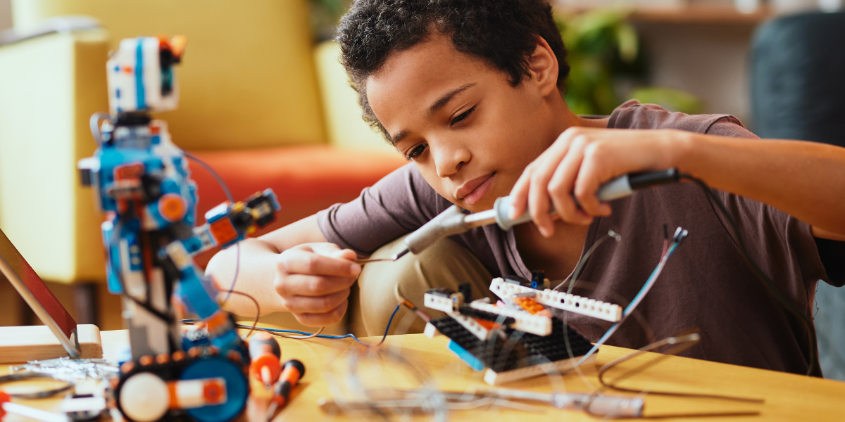 A kid building his newest invention.