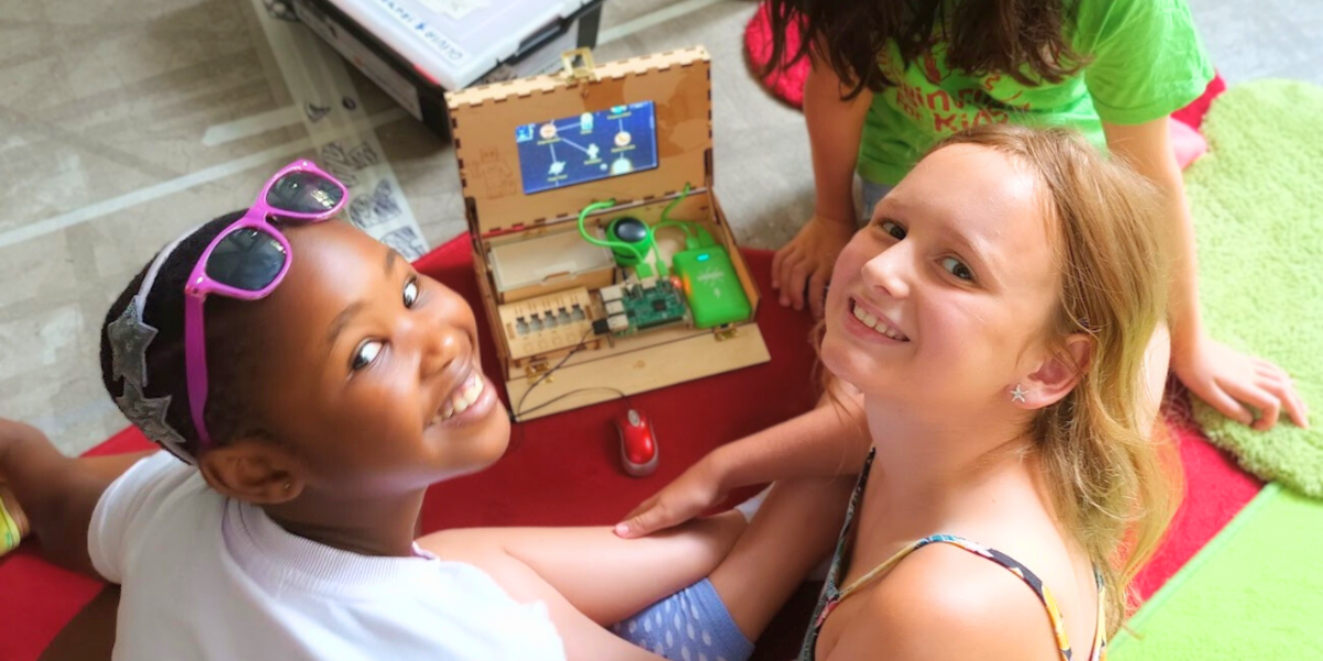 A group of girls smiles and collaborates as they tackle coding challenges, discovering the excitement and empowerment that comes with learning to program.