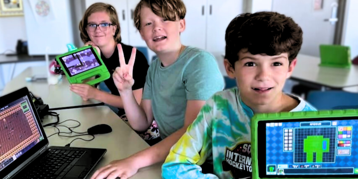 A group of enthusiastic children gather around a laptop, working together to create and troubleshoot a computer program. Their teamwork and curiosity highlight the fun of exploring engineering concepts.