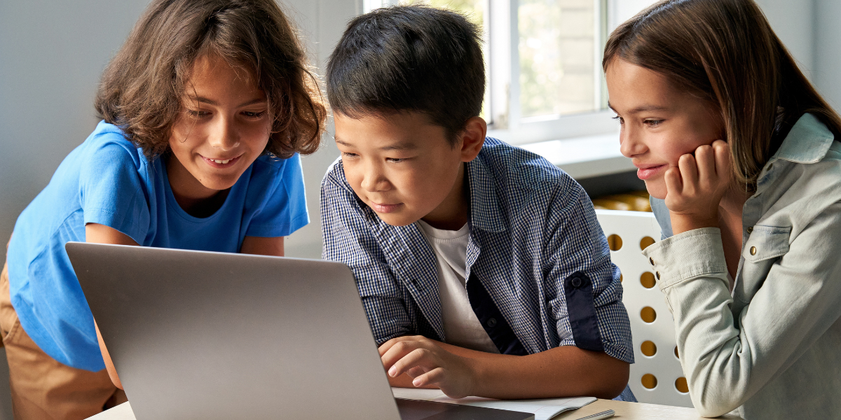 A group of children using affordable laptops designed for online classes, fostering interactive virtual education experiences.