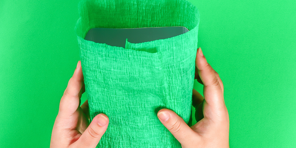 The first step in building a leprechaun trap, where children decorate a recycled box with vibrant green paper and festive designs to start their magical St. Patrick's Day project.